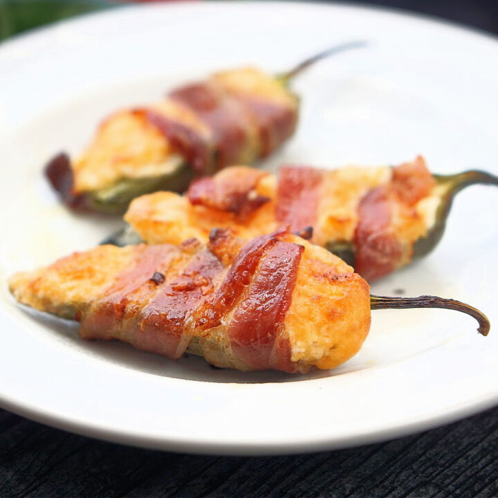 white plate with 3 bacon wrapped keto jalapeno poppers