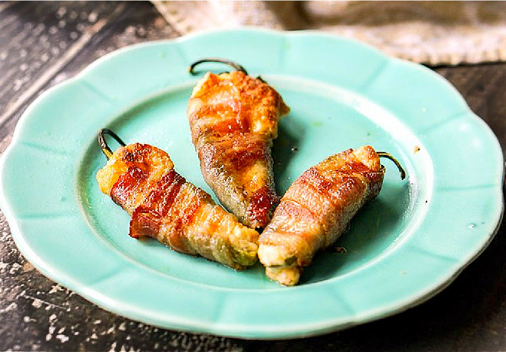 blue plate with 3 baked stuffed jalapeno poppers