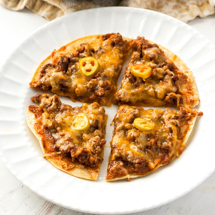 white plate with 4 beef nachos