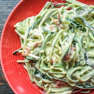 These easy creamy sun dried tomato & basil zoodles only take 15 minutes to make. The zucchini noodles have a creamy garlic, basil and sun dried tomatoes sauce that is decadent and delicious.