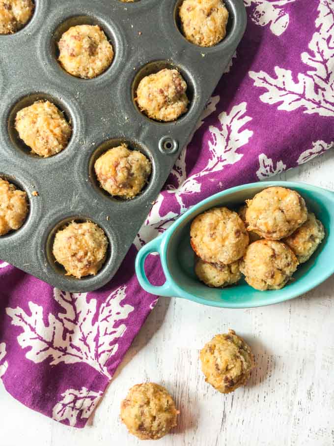 muffin tin with sausage mini muffins , blue bowl and purple tea towel