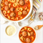 white bowls with meatball and tortellini soup with text
