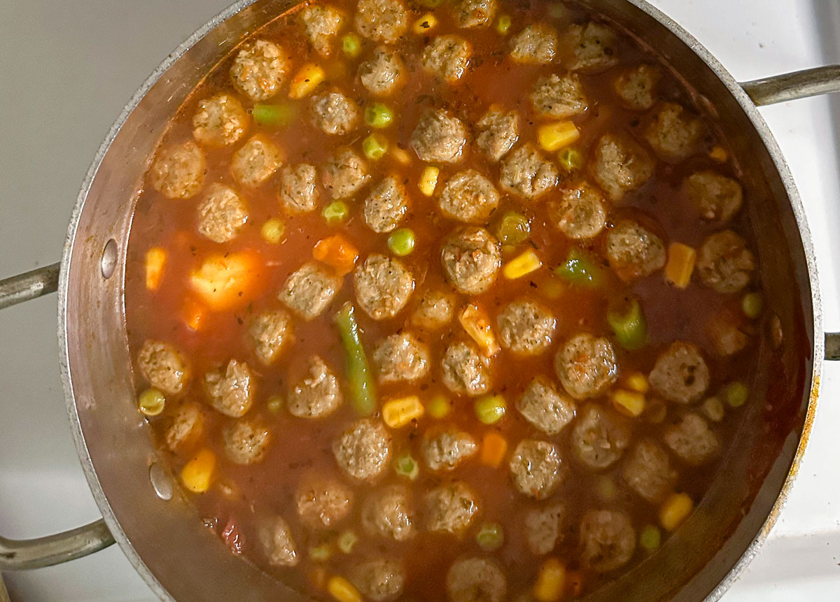 soup pot with meatballs and veggies and broth
