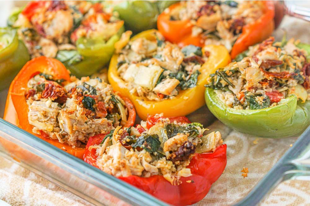 closeup of a pan of colorful bell pepper halves with chicken stuffing