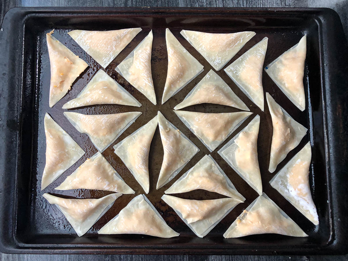 baking sheet with unbaked wontons