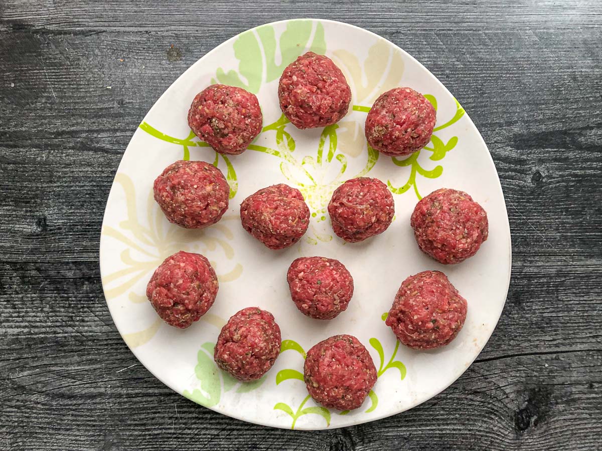 plate with raw healthy meatballs