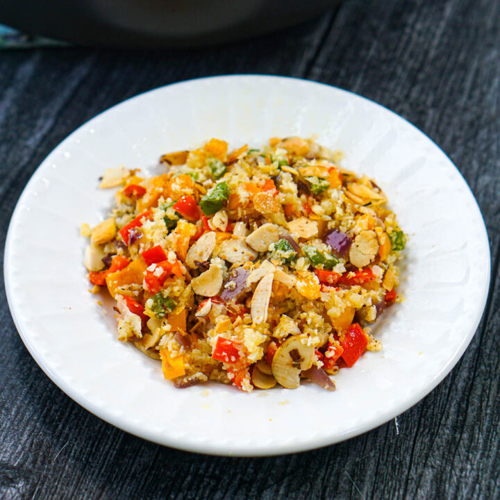 white plate with keto cauliflower rice pilaf with peppers