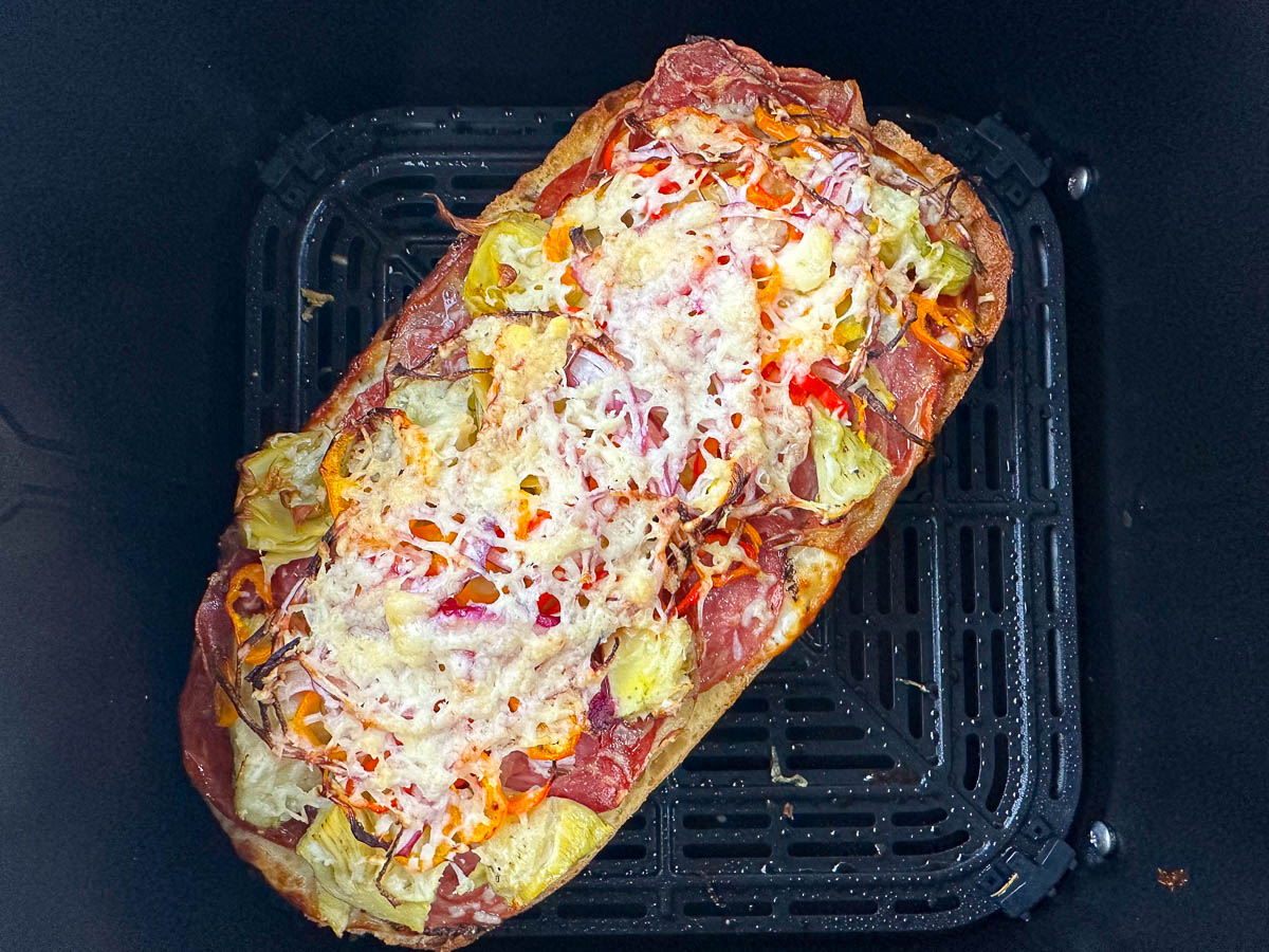 finished antipasto pizza in air fryer basket
