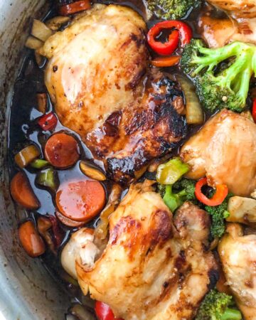 aerial view of a pan of chicken thighs and veggies stir fry