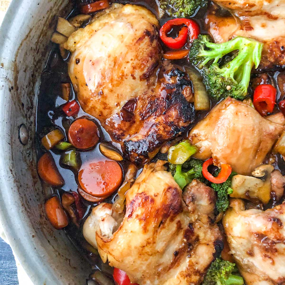 aerial view of a pan of chicken thighs and veggies stir fry