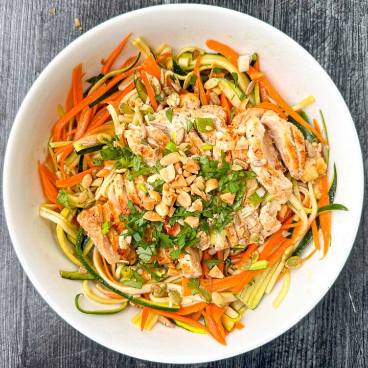 white bowl with finished veggie noodles and chicken breast