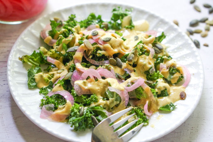 closeup of kale salad with pickled onions and lemon dressing