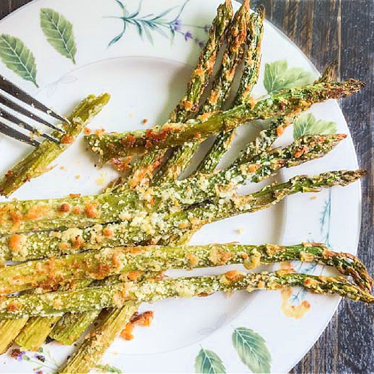 closeup of a decorative plate with parmesan roasted asparagus