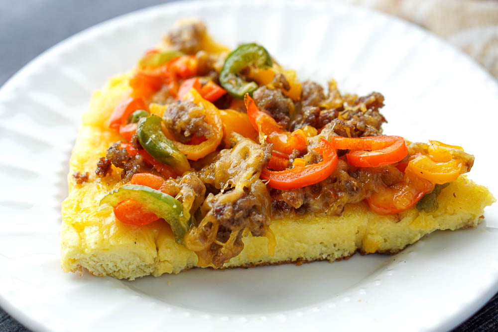 closeup of a piece of breakfast frittata with sausage and peppers