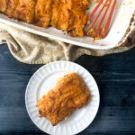 pan and white dish with chicken enchiladas and text