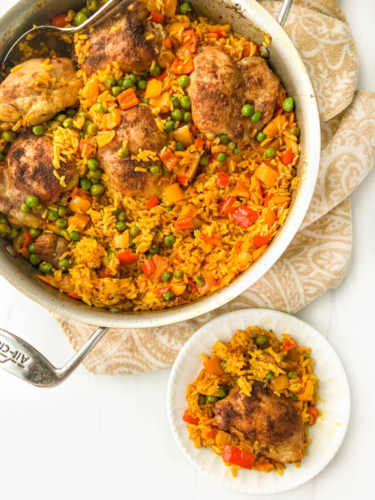 aerial view of a pan and white dish with colorful chicken and rice dish