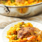 white plate and silver pan of Spanish chicken and rice with text overlay