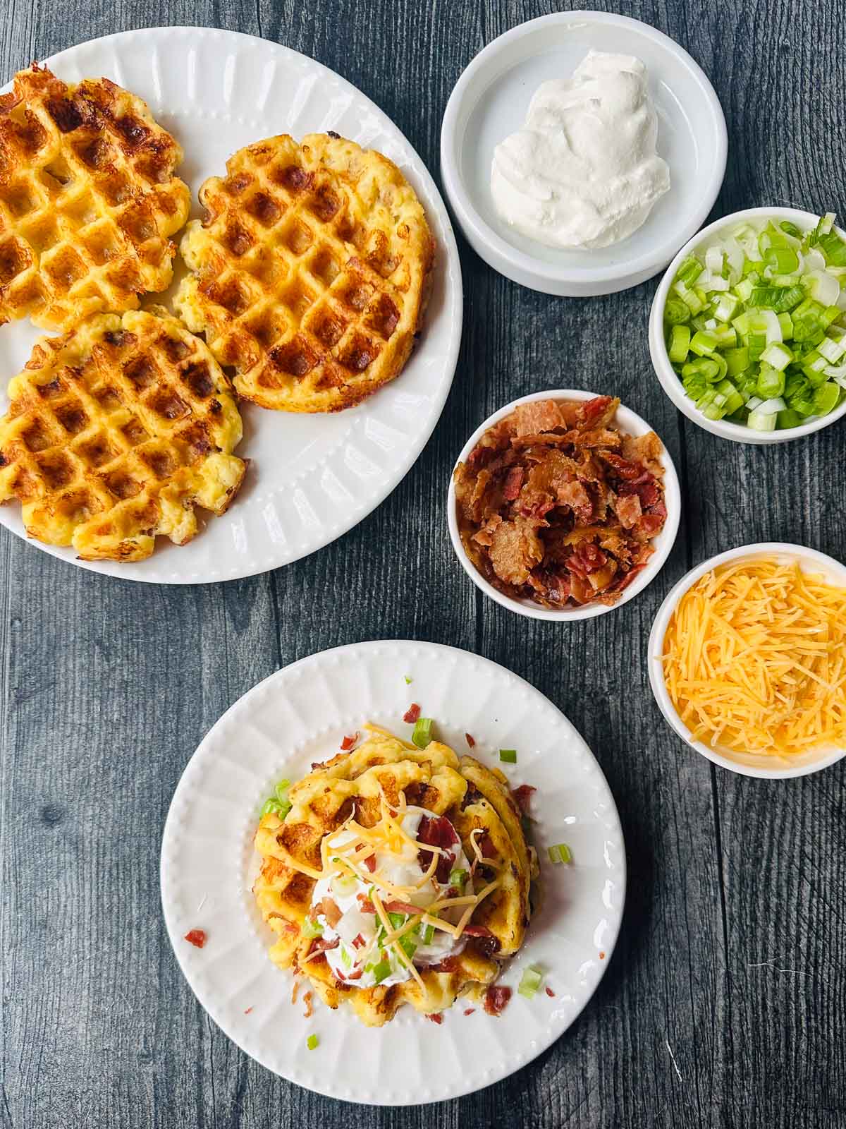 aerial view of plates with potato waffles and small plates with toppings