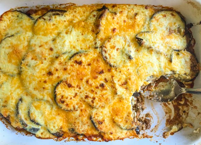 My mom's moussaka is a family favorite for we love the cinnamon spiced meat sauce and eggplant topped with creamy cheese sauce. Tastes great over rice. #SundaySupper