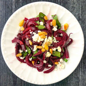 beetroot and goat cheese salad on a white plate