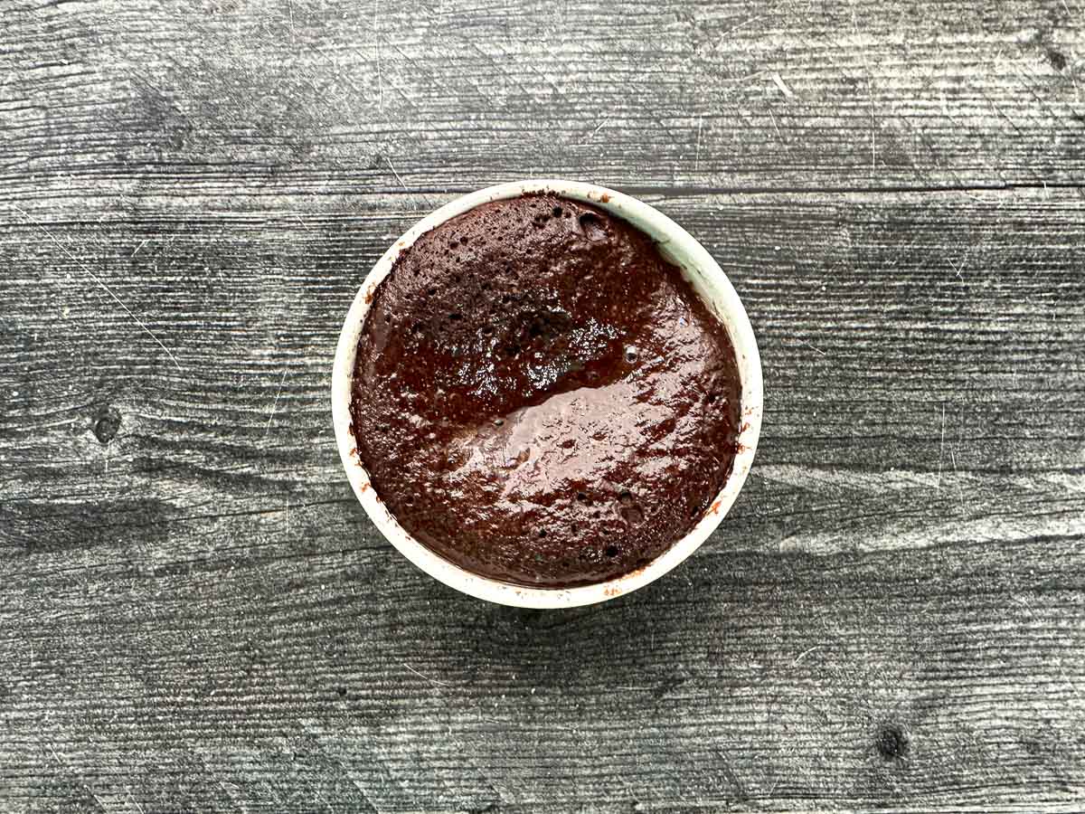 Aerial view of ramekin with baked keto chocolate cake.