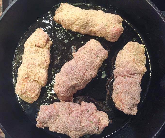 breaded pork city chicken in a frying pan