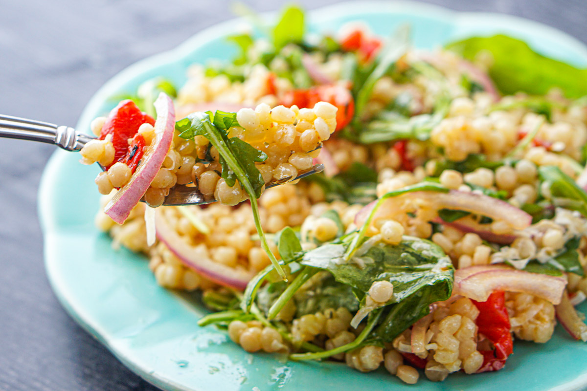 closeup of a forkful of Israeli couscous salad
