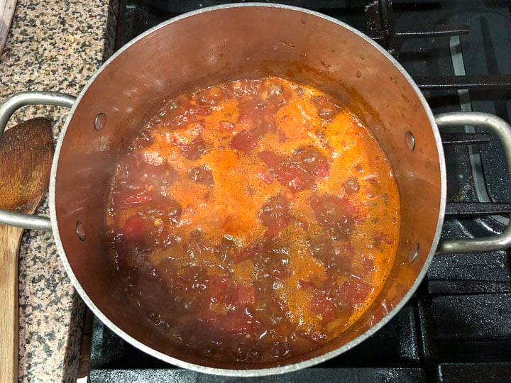 pot with the red lentil chili starting to simmer on the stove