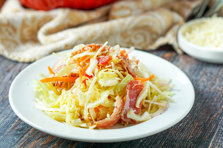 closeup of white plate with cabbage slaw with antipasto ingredients