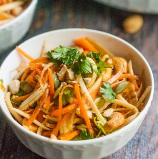 This crunchy Asian parsnip & carrot salad is fresh and tasty and you can make it in minutes. Lots of crunch from veggies, seeds and nuts tossed in an Asian dressing.
