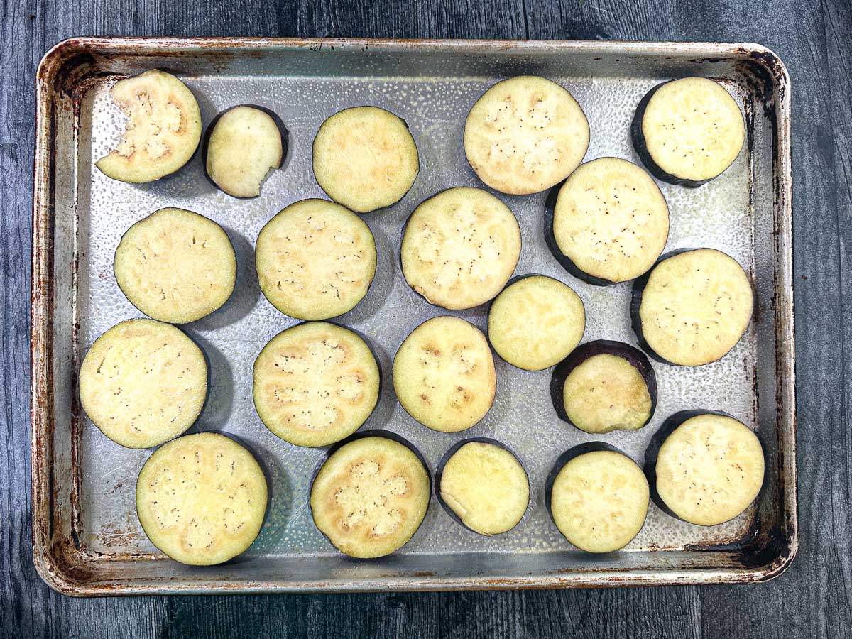 Baking sheet with sliced eggplant.