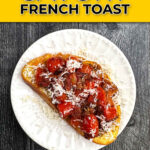 White plate with a piece of savory French toast topped with roasted tomatoes, bacon and sprinkling of parmesan cheese and text.