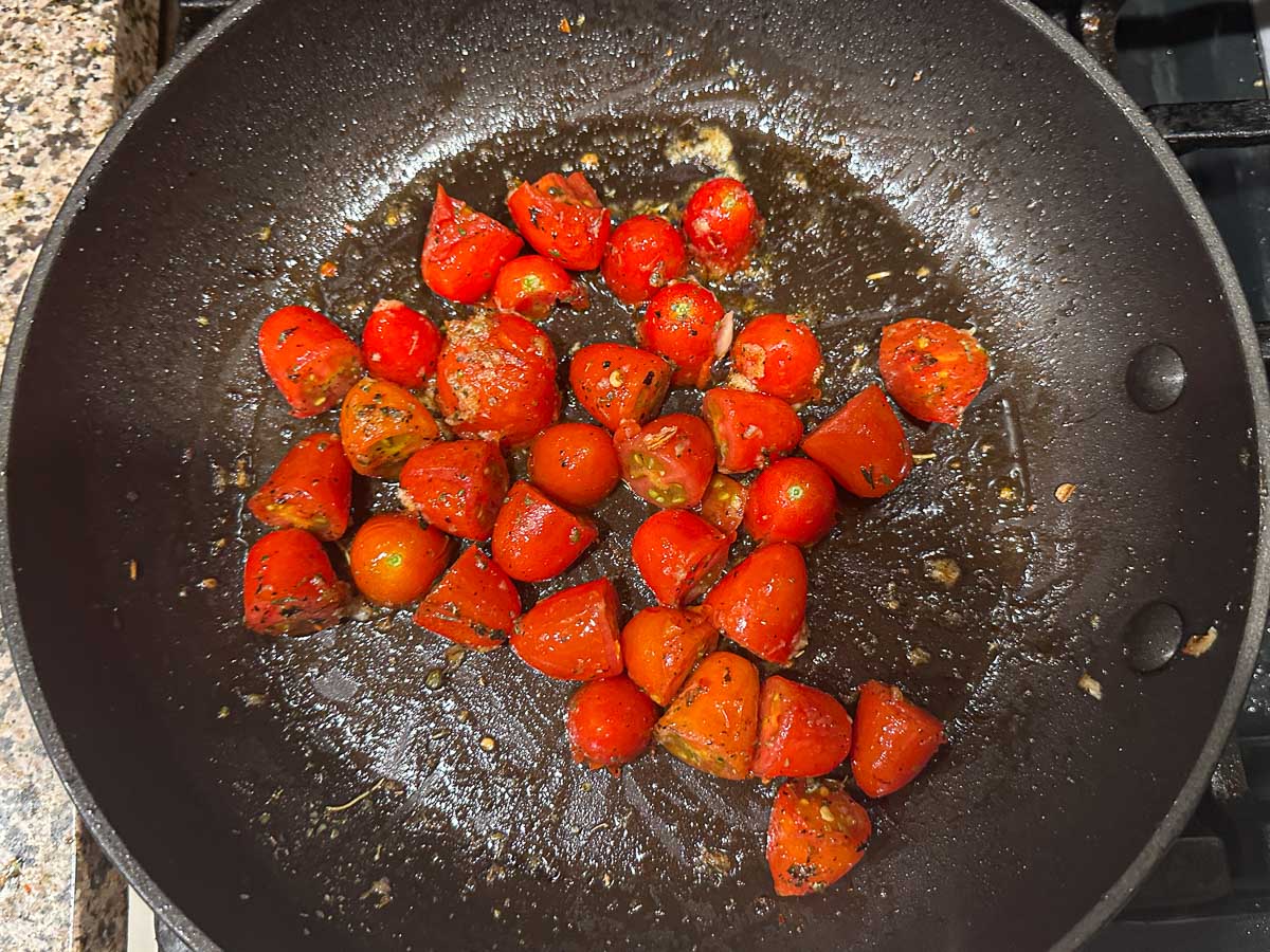 Pan with grape tomatoes and spices.
