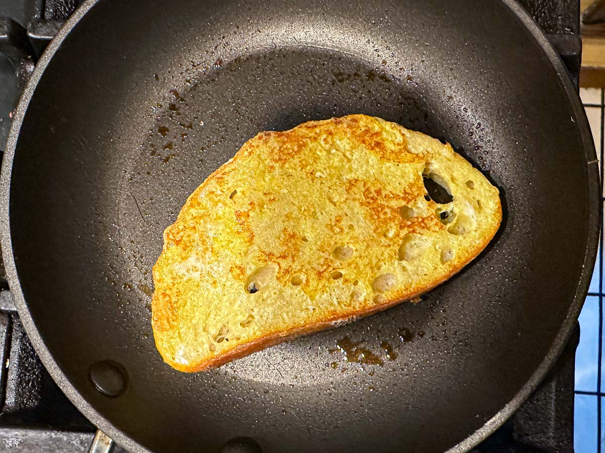 Pan with a piece of French toast being made.