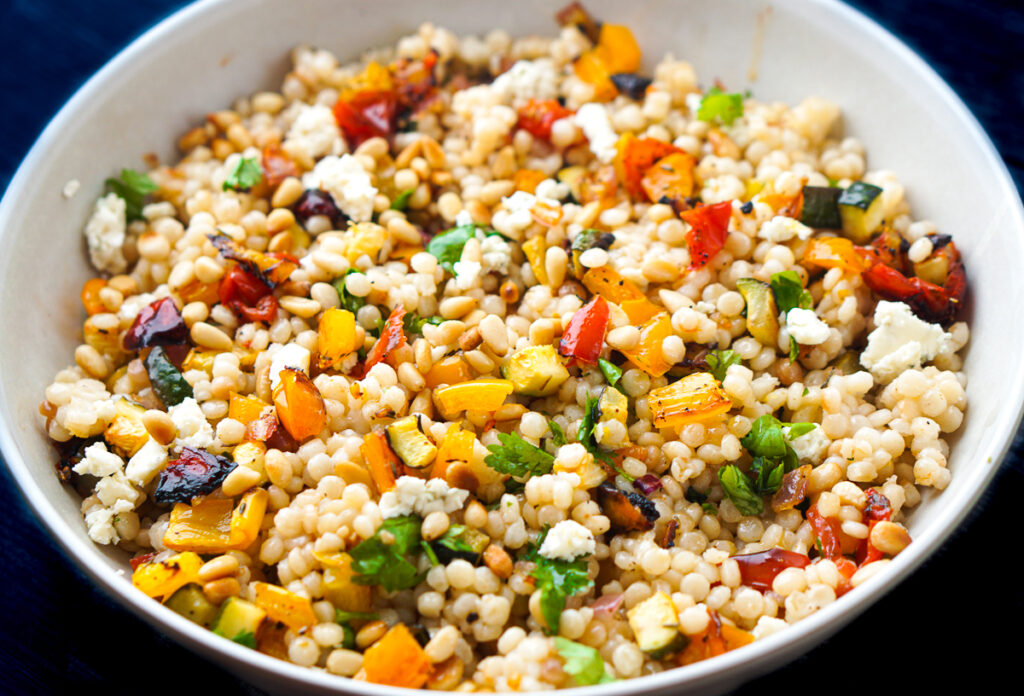 white bowl with roasted vegetable salad with couscous