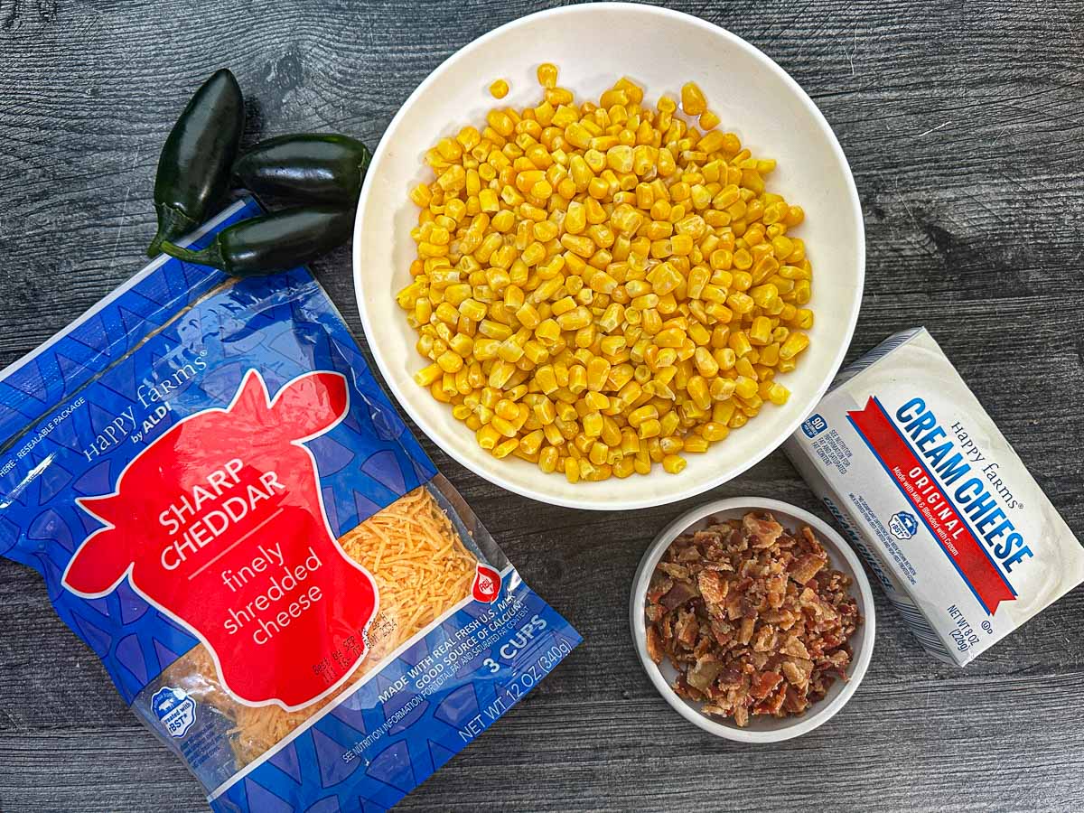 Recipe ingredients - corn kernels, cheddar cheese, jalapenos, bacon crumbles and cream cheese.