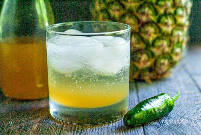 This pineapple jalapeño shrub cocktail has the sweetness of pineapple, the tang of vinegar and the heat of jalapeños. Great with seltzer or vodka for a refreshing summer drink.