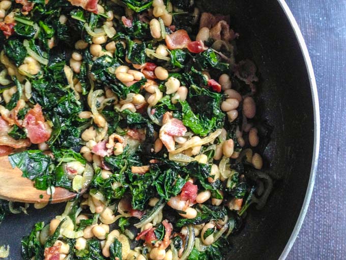 These easy bacon beans & greens are the perfect way to use greens from your garden. Serve as a hearty side dish or as a main course. #SundaySupper