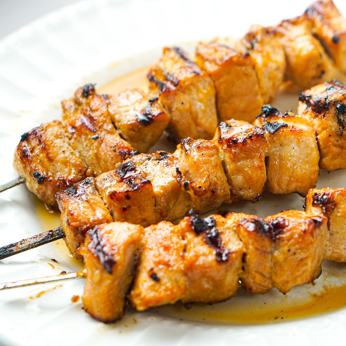 white plate with keto grilled pork kebabs