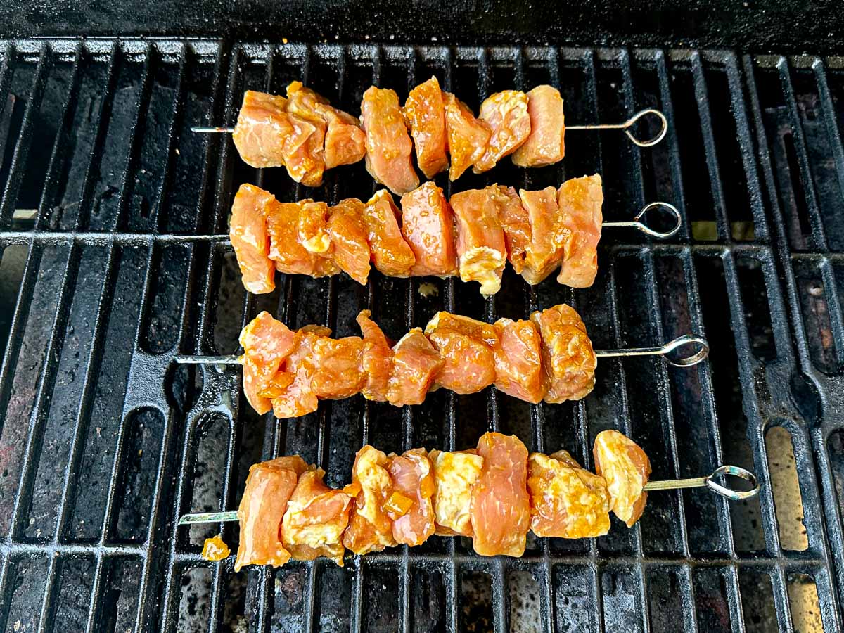 marinated pork skewers  on grill grate