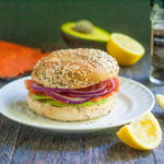 This smoked salmon bagel sandwich has it all. Lemons, smoked salmon, red onions, avocados all on an everything bagel.