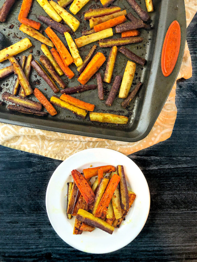 aerial view of a baking tray and dish with curried carrots