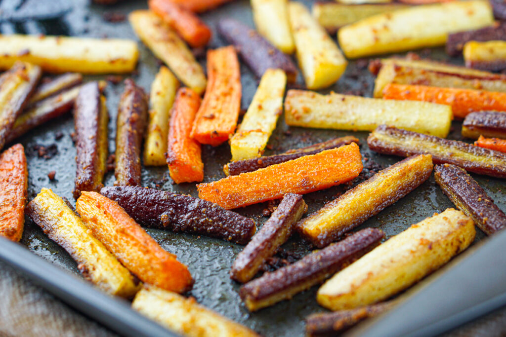 closeup of a tray of roasted curry carrots