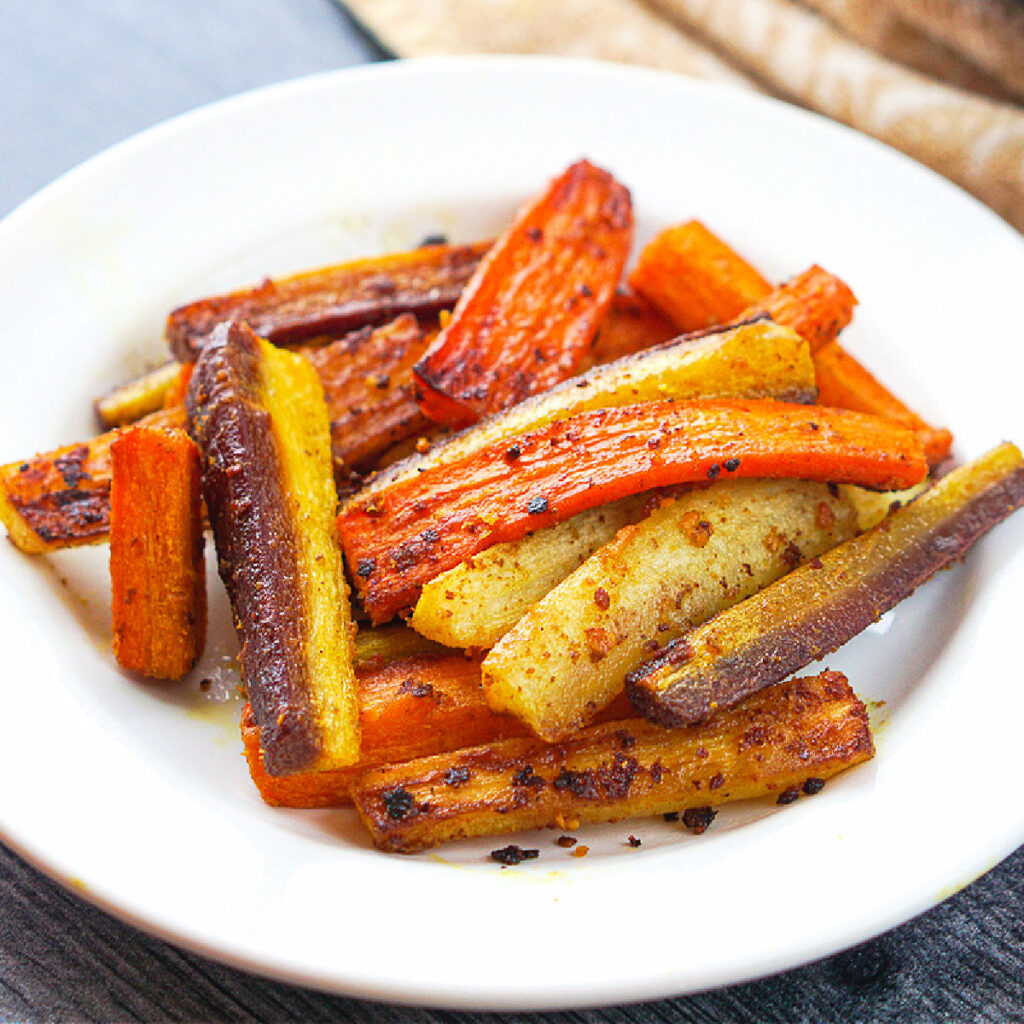 white dish with a serving of roasted carrots