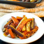 white plate with roasted curry carrots and text