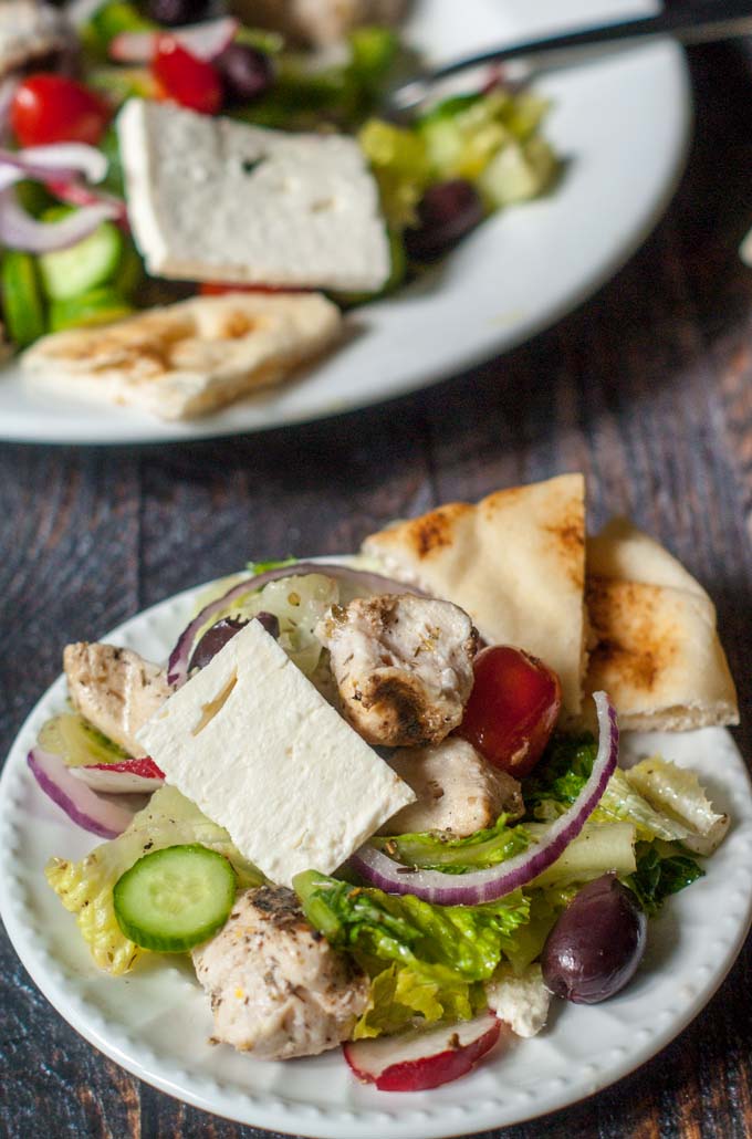 This easy Greek chicken salad is filled with tasty Mediterranean goodies and topped with chicken kebabs. Serve with pita bread for a light but tasty dinner.