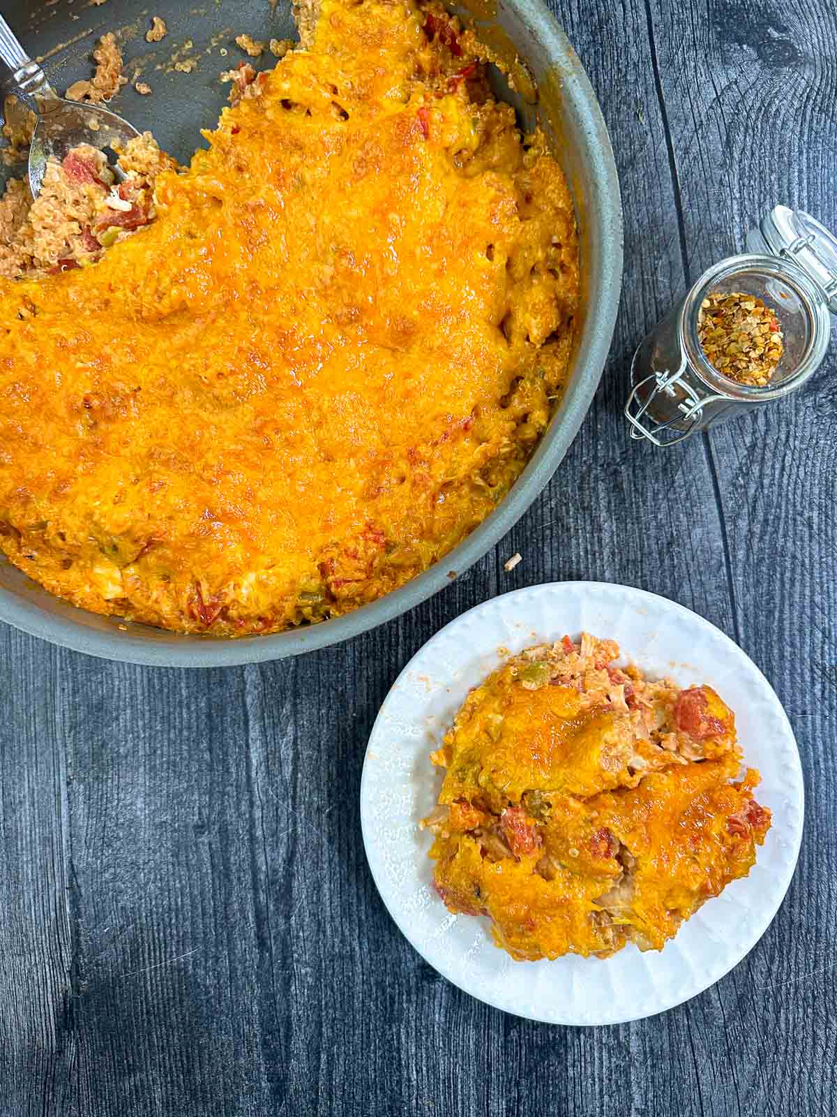 aerial view of a skillet and plate with the buffalo chicken casserole