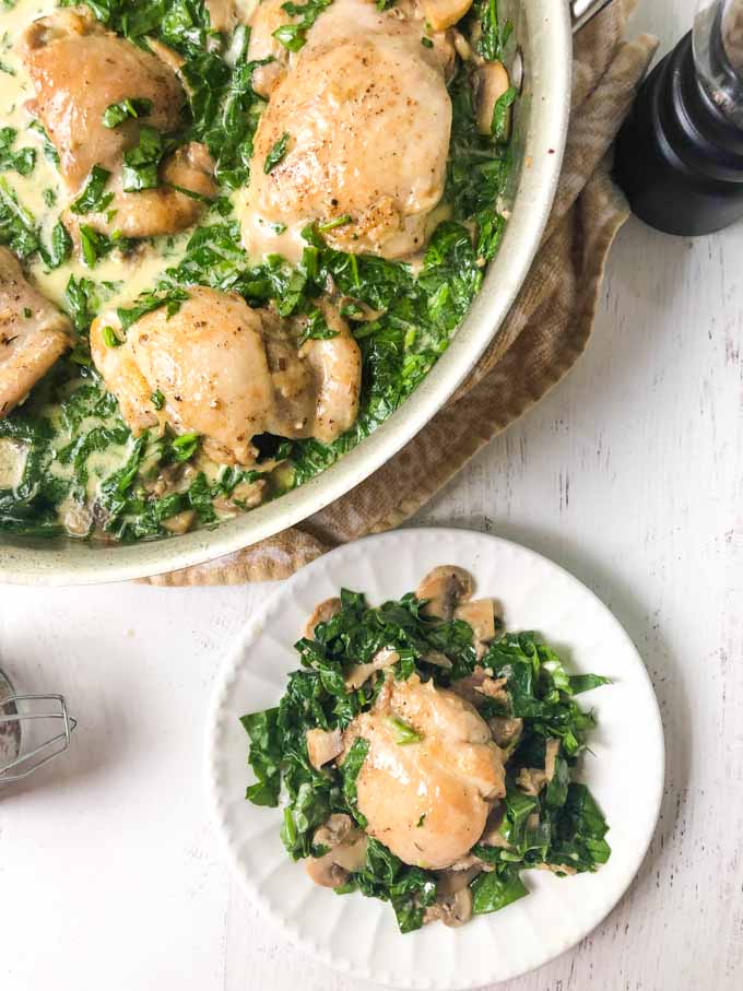 pan and white dish with creamy chicken and spinach