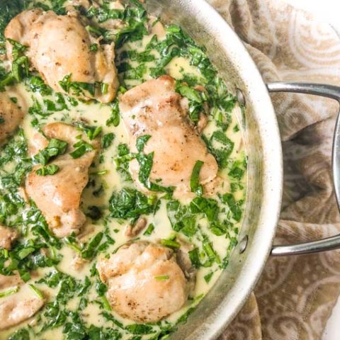 close up of low carb chicken skillet dinner with spinach and mushroom sauce
