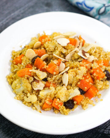 vegetable curry quinoa pilaf on white plate